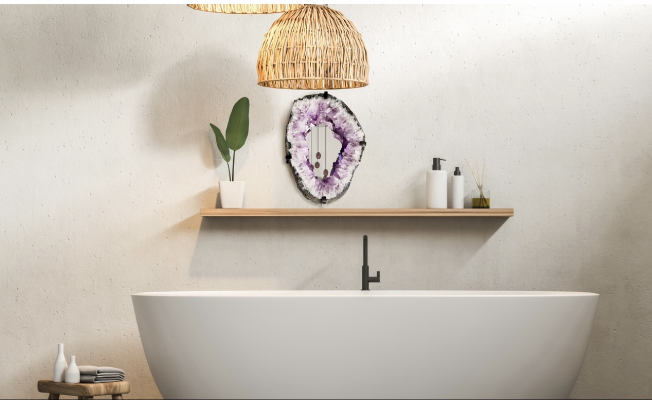 Serene bathroom with a freestanding white tub, an amethyst geode mirror above a wood shelf and woven pendants above